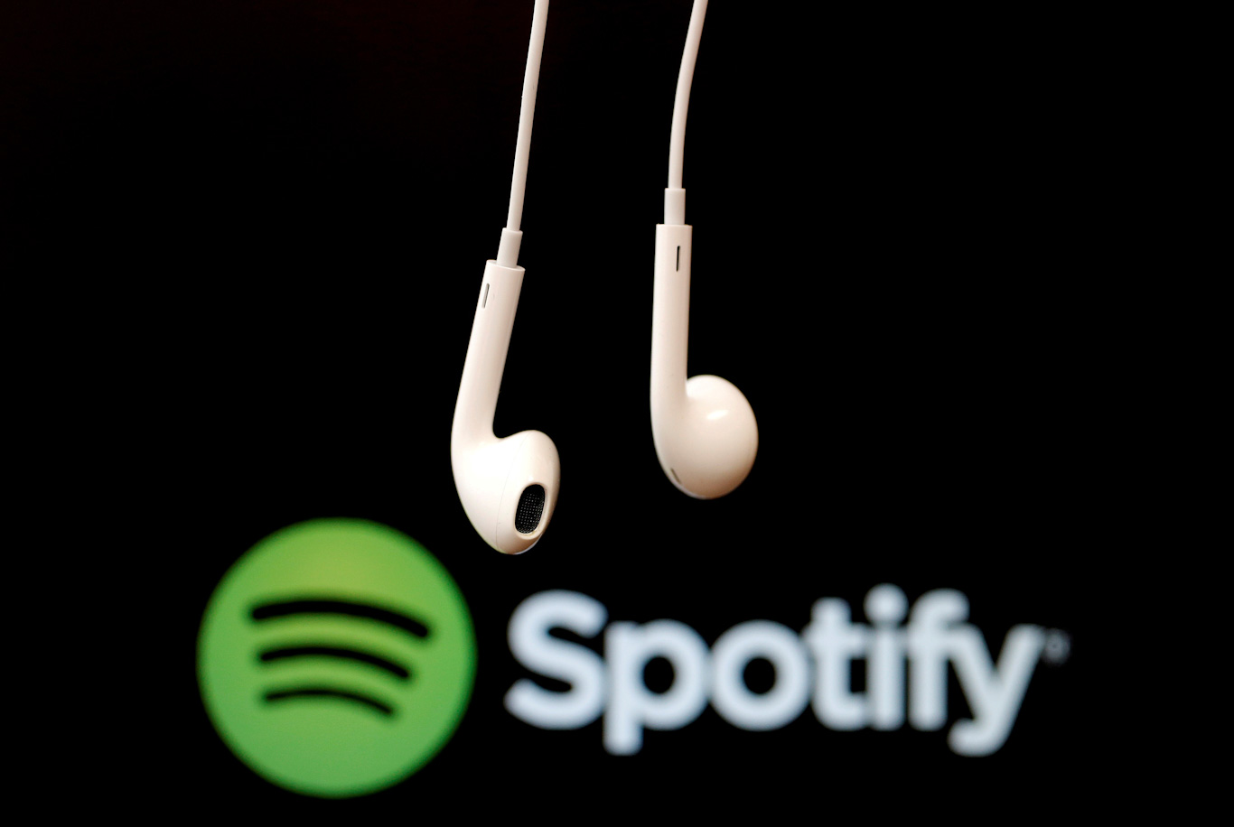 FILE PHOTO: Headphones are seen in front of a logo of online music streaming service Spotify