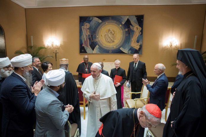 Pope Francis talks with members of the