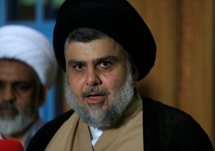 Iraqi Shi'ite cleric Moqtada al-Sadr speaks during a news conference with Leader of the Conquest Coalition and the Iran-backed Shi'ite militia Badr Organisation Hadi al-Amiri, in Najaf