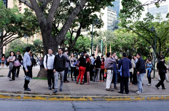 People gather in the street after an earthquake in Caracas