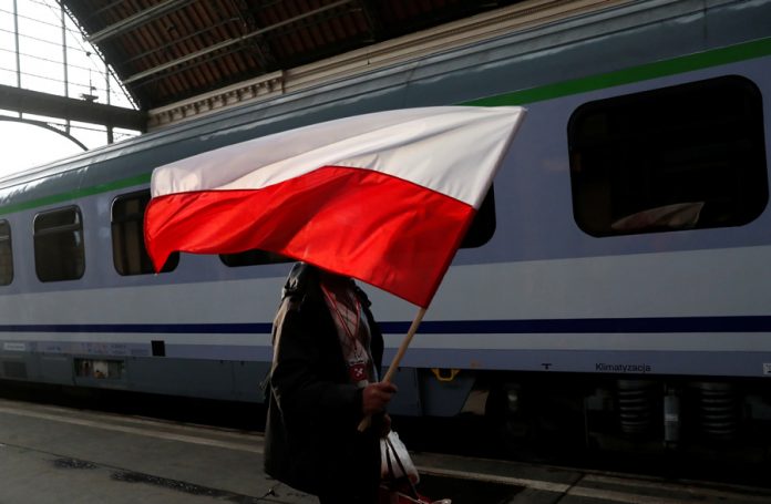 A Polish right-wing activist arrives at Keleti station to join the pro-Orban march to be held on the anniversary of the 1848 Hungarian Revolution in Budapest