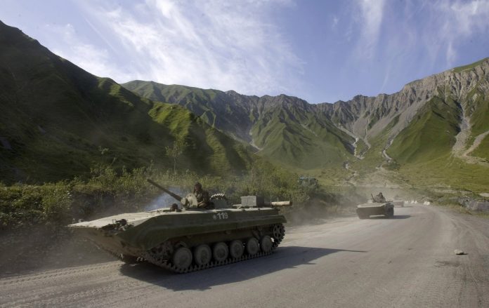 Russian military vehicles drive in direction of Tskhinvali after crossing from Russia into South Ossetia