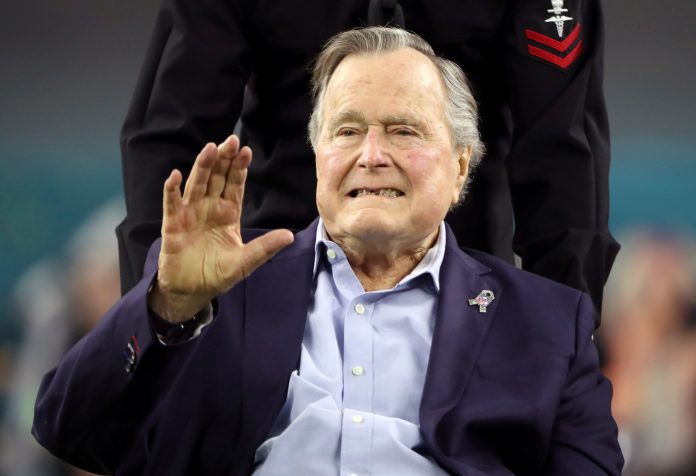 FILE PHOTO: FILE PHOTO - Former U.S. President George H.W. Bush arrives on the field ahead of the start of Super Bowl LI between the New England Patriots and the Atlanta Falcons in Houston