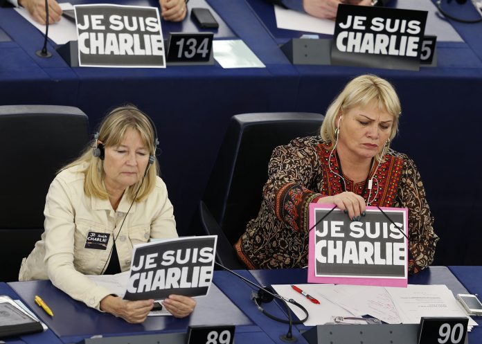Members of the European Parliament Marita Ulvskog and Soraya Post, of Sweden, place placards which read