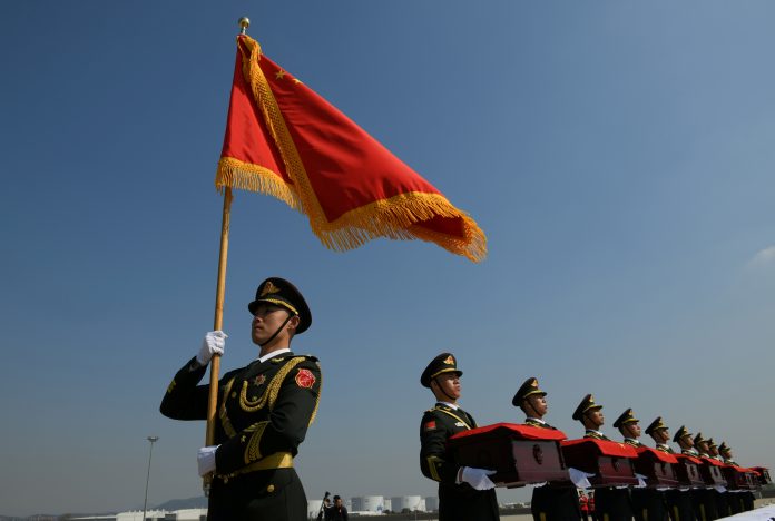 Chinese honour guards hold caskets containing the remains of Chinese soldiers during the handing over ceremony at Incheon International Airport in Incheon