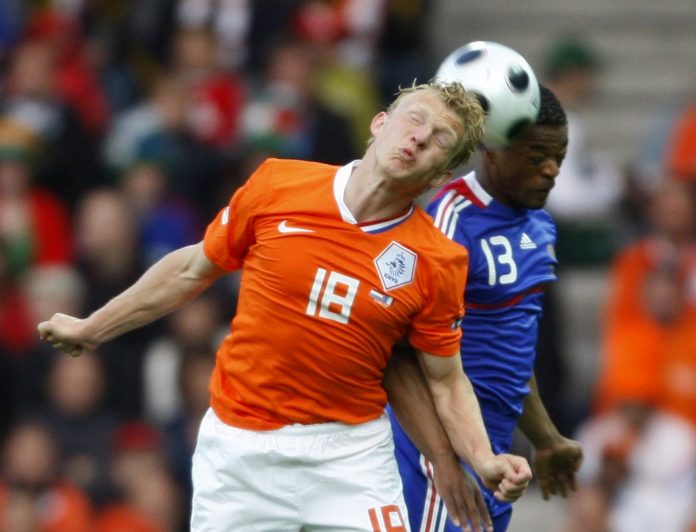 Netherlands' Kuyt and France's Evra jump up for the ball during Euro 2008 soccer match in Bern